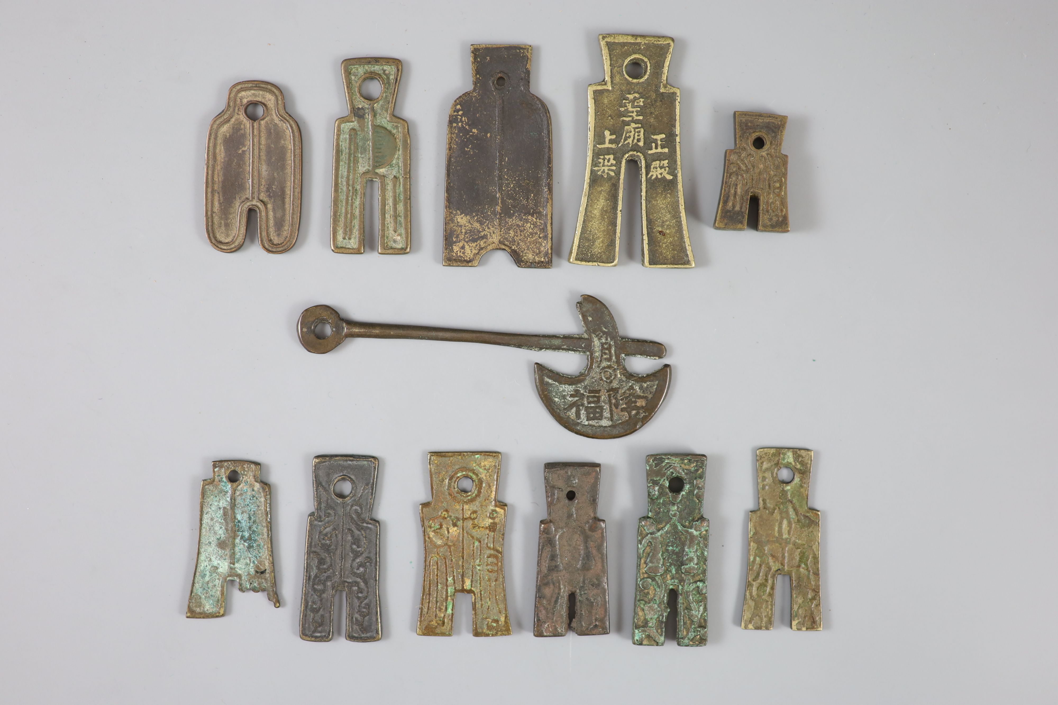 China, 11 bronze spade shaped charms or amulets, Qing dynasty,